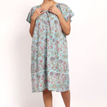 Front view of model in lightweight floral nightie with buttoned neckline and flutter sleeves.