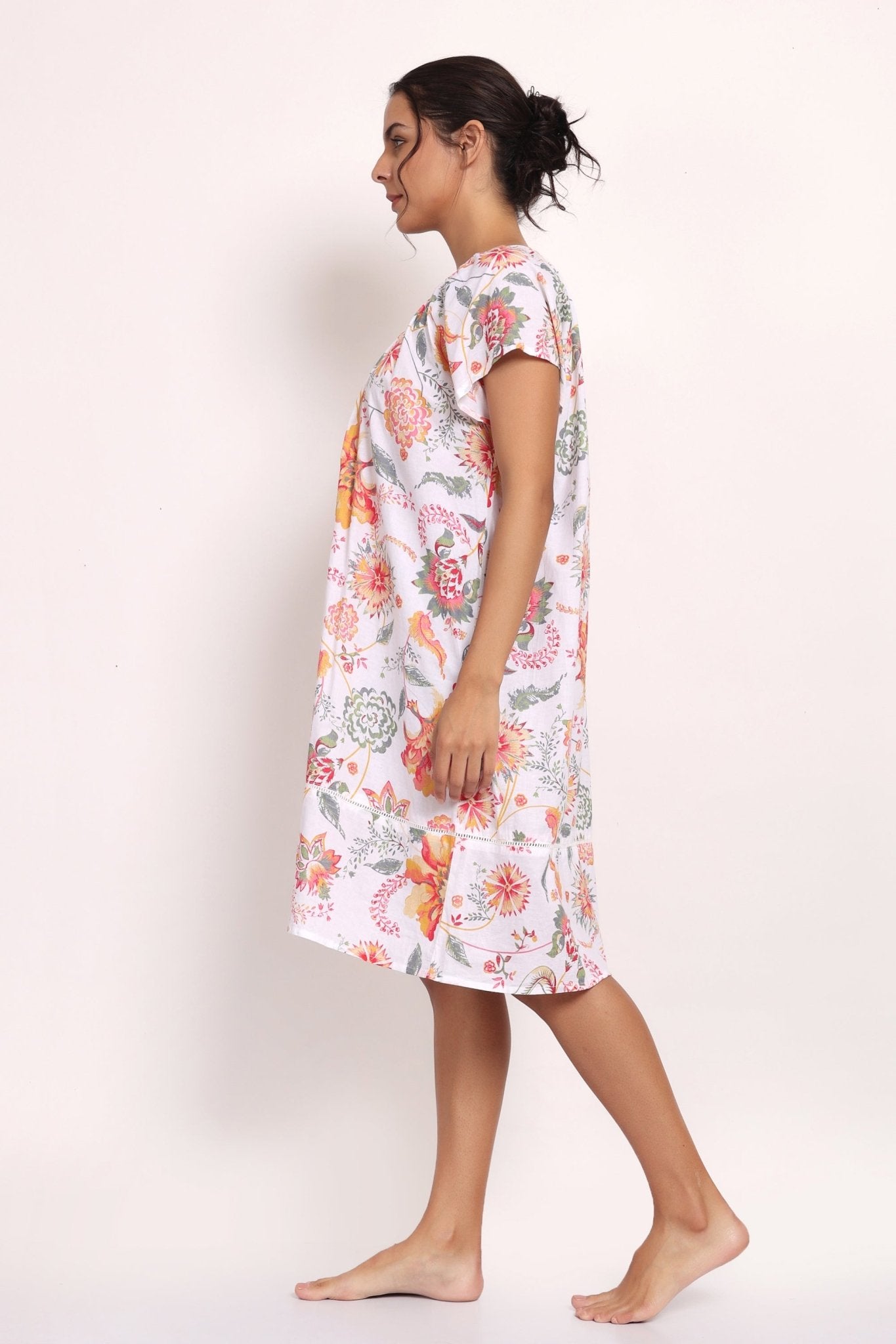 Side view of model walking in loose-fitting floral nightie, perfect for summer comfort.