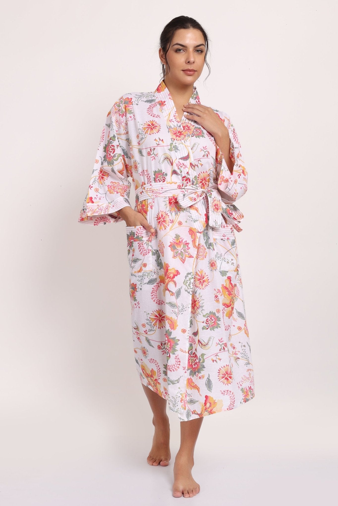 Full-length view of Passionflower Kimono in cotton coral botanical print, perfect for summer lounging.