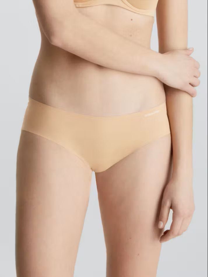 Front view of Calvin Klein Invisibles Hipster Light Caramel, a seamless nude microfibre brief for a smooth, invisible fit.