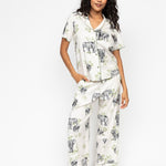 Front view of the Cyberjammies Eloise Elephant Print Pyjama Set, showing the sage-green trimmed revere top and wide-leg bottoms with drawstring waist.