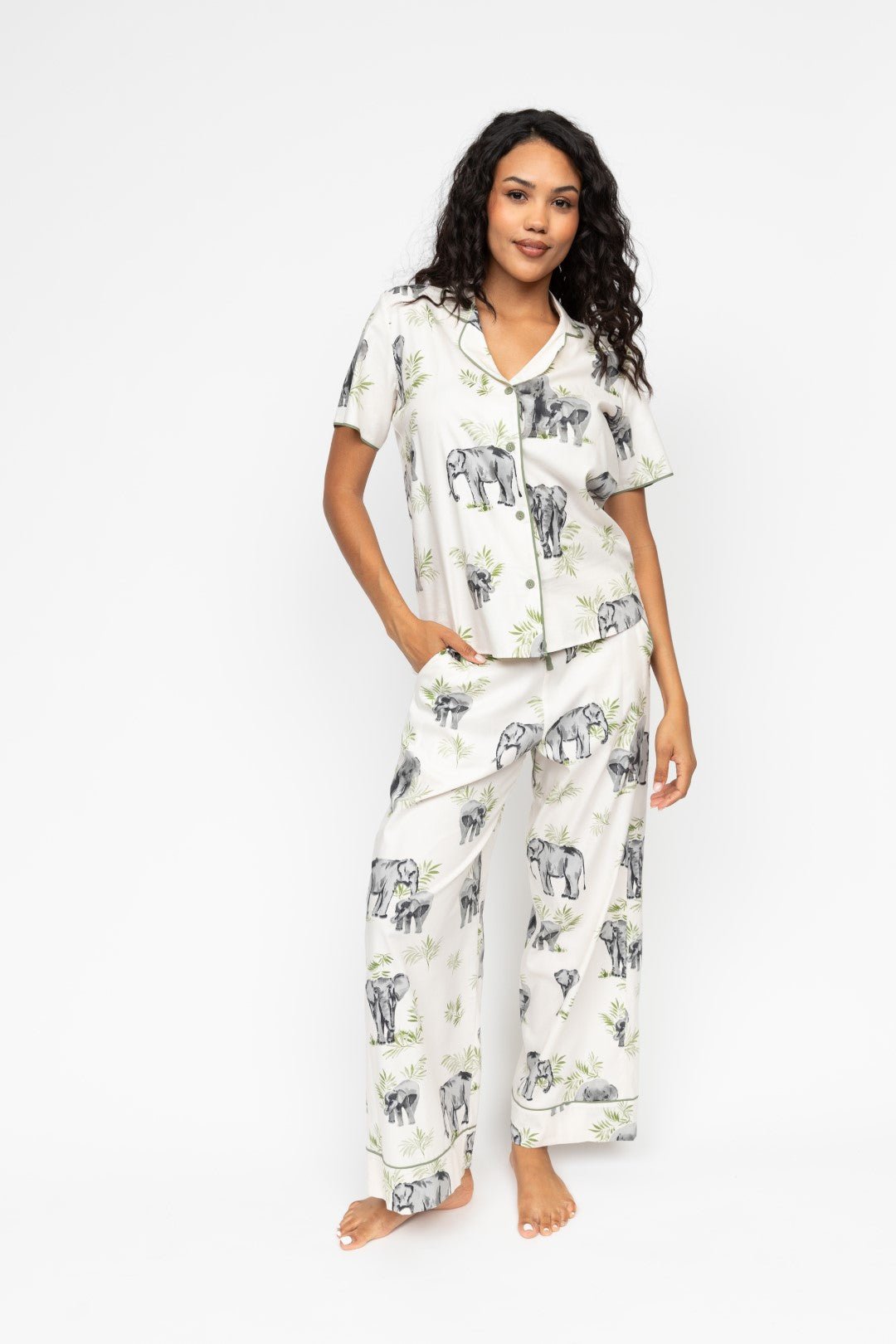 Front view of the Cyberjammies Eloise Elephant Print Pyjama Set, showing the sage-green trimmed revere top and wide-leg bottoms with drawstring waist.