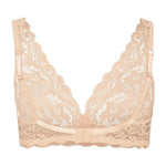 Flay lay view of the back of a beige lace bra on a white background