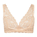 Flay lay view of the back of a beige lace bra on a white background