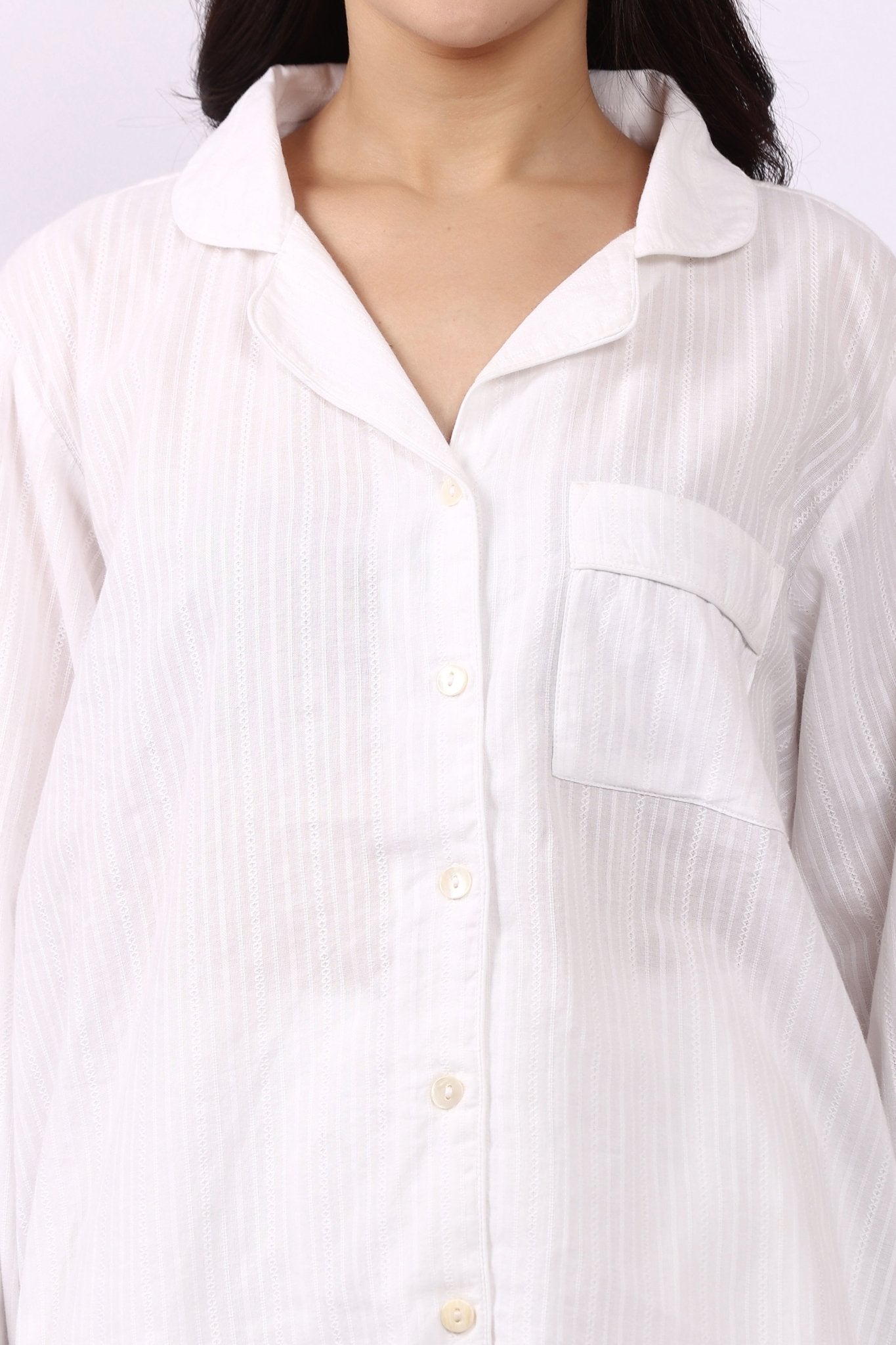 Close-up of revere collar cotton pyjama shirt with self-stripe and chest pocket.