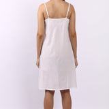 Back view of Lotus white cotton slip with adjustable straps, breathable woven cotton.