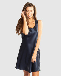 Model wearing Mono Silk Short Nightie in navy, featuring a flattering low neckline, wide straps, and a draped silk finish just above the knee.
