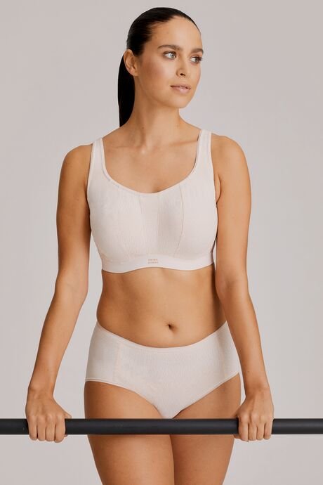 Full-body view of model wearing the Gym Sports Bra in Venus with activewear styling.