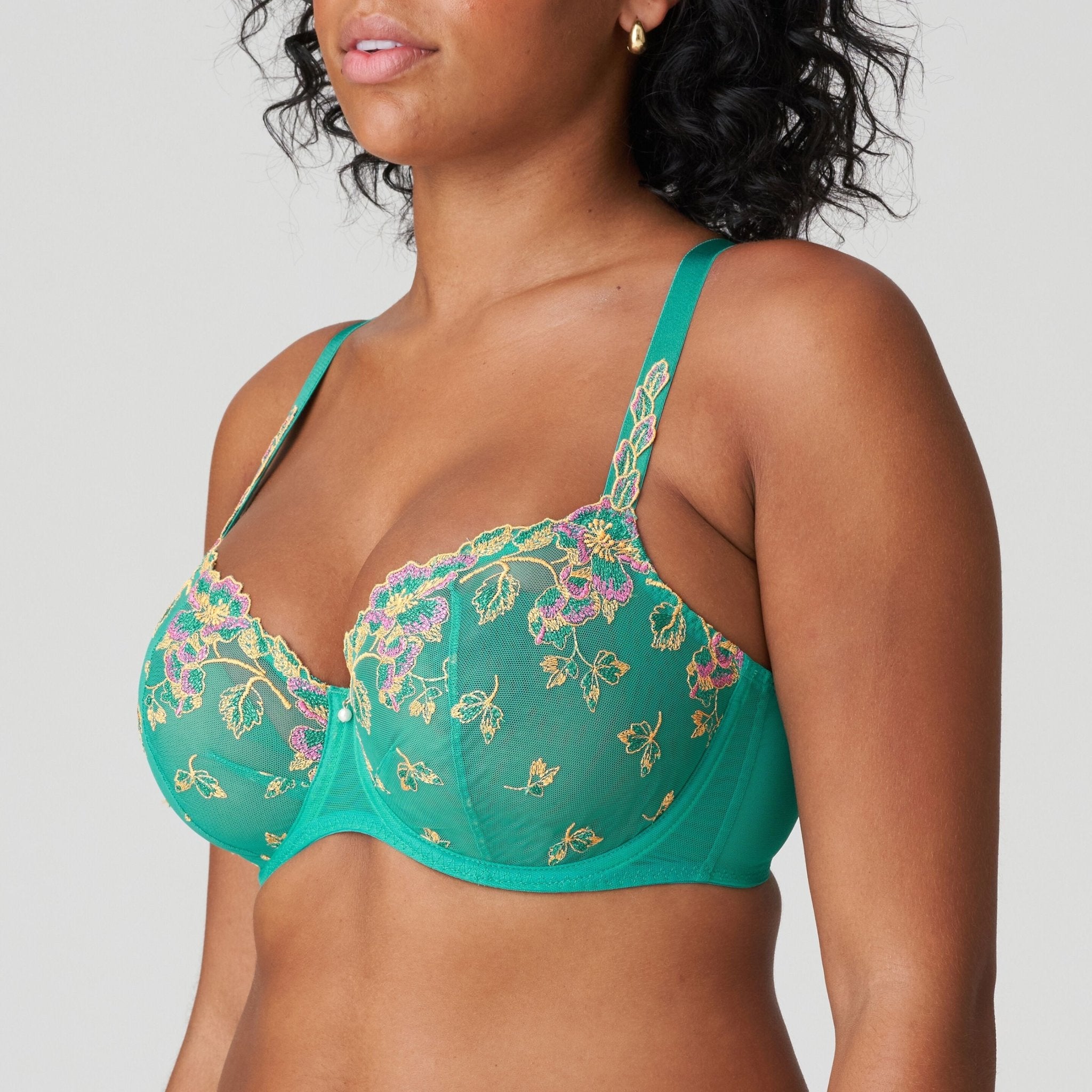 Model wearing Lenca Balcony Bra Sunny Teal from The Foundation, angled front to showcase luxurious guipure lace and flattering balcony shape