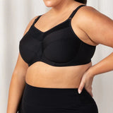 Side profile of Triaction Ultra Sports Bra Black, highlighting double-layer cups and padded straps