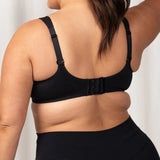 Back view of Triaction Ultra W Sports Bra in Black, featuring adjustable hook and eye closure