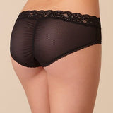 Model wearing Passionata Brooklyn Shorty Brief in Black from The Foundation, featuring lace-trimmed edges, sheer mesh back, and a medium-rise fit. back view