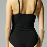 Back view of Simone Perele’s Caresse 3D Control Bodysuit Black from The Foundation – smooth finish ideal under fitted clothing.