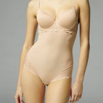 Front view of the Simone Perele Caresse 3D Control Bodysuit Peau Rose, available at The Foundation – shaping mesh and lace detail shown on model.