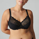 Model wearing Simone Pérèle Caresse Full Cup Bra in Black from The Foundation, featuring 3-part supportive cups, lace finish, and cotton lining. close up