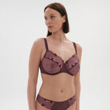 Model wears the Dahlia Full Cup Control Bra Byzantine, showing dusky pink embroidery and flattering support from The Foundation.