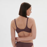 Side profile of model in Dahlia Full Cup Control Bra Byzantine, showing supportive fit and comfort from The Foundation.