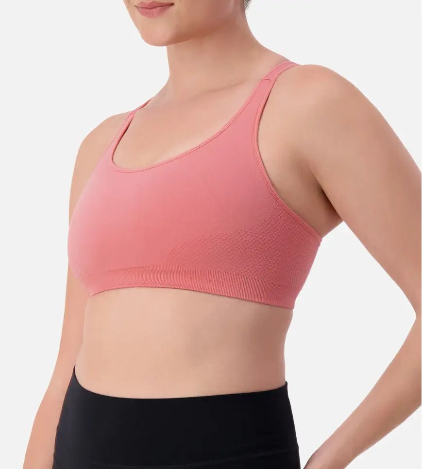 Triaction Ultra Seamfree Top in Salsa Pink by Triumph shown on model, wireless activewear crop with cross-back straps and double-layered support
