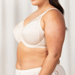 Side view of Triumph Endless Comfort Bra in soft Fresh Powder shade with multi-piece cup and underwire—shop now at The Foundation.