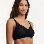 Side profile of C Magnifique Black wireless bra showing smooth silhouette and lightly padded adjustable straps.