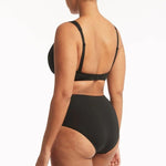 Sea Level Essentials Gathered Side High Waist Swim Pant in Black with ruched sides, high rise waist, and full bottom coverage, BACK VIEW – available at The Foundation