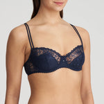 Angle view of Jane Half Padded Balcony Bra Velvet Blue from The Foundation, displaying the flattering fit and stylish straps