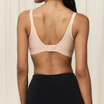 Back view of the Triaction Wellness bra Neutral Beige, featuring mesh-lined cups and adjustable straps.