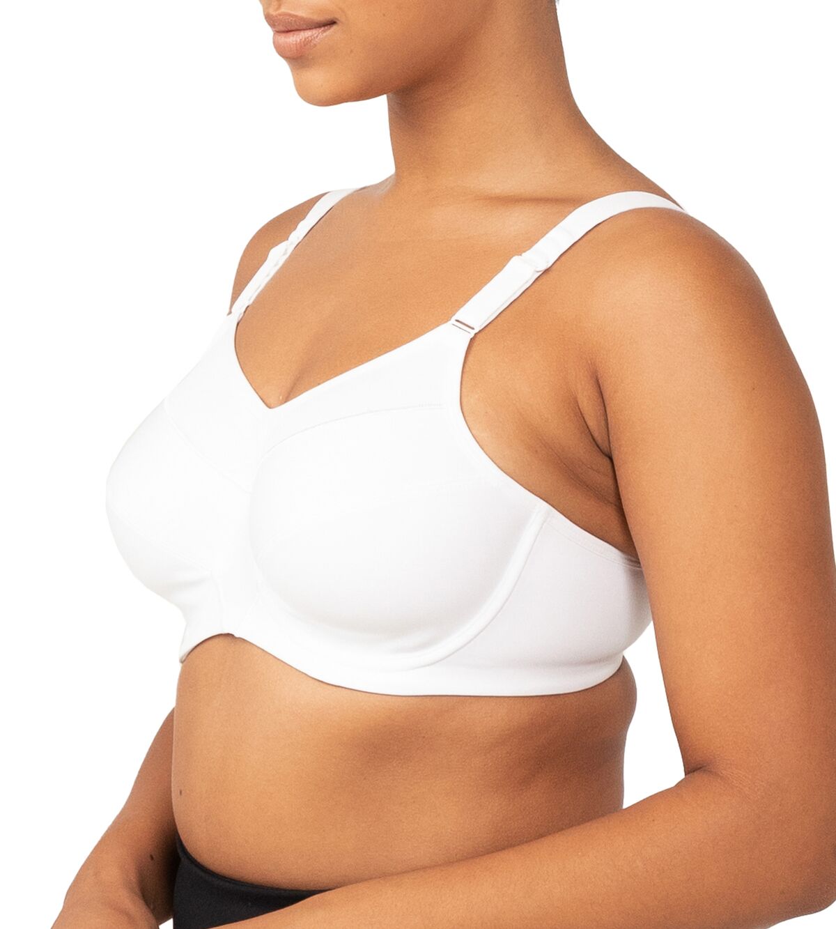 Side profile of a model wearing the Triaction Ultra W Sports Bra White, highlighting underwired support.