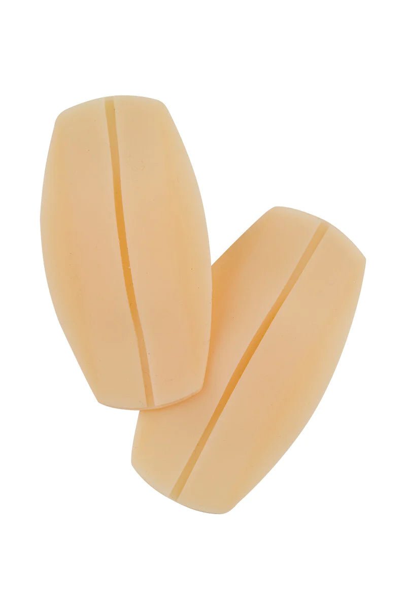 Pair of nude-coloured silicone bra strap cushions, designed to reduce strap slippage and shoulder pressure.