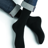 Model wearing Wool Cashmere Socks Mid Noir by Bleuforêt, available at The Foundation, showcasing soft, warm, black socks perfect for boots and winter wear.