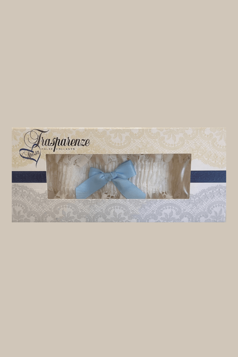 Packaged ivory lace garter with light blue bow by Trasparenze, available at The Foundation, the perfect bridal accessory for a wedding tradition.