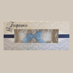 Packaged ivory lace garter with light blue bow by Trasparenze, available at The Foundation, the perfect bridal accessory for a wedding tradition.