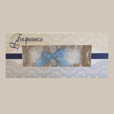 Packaged ivory lace garter with light blue bow by Trasparenze, available at The Foundation, the perfect bridal accessory for a wedding tradition.