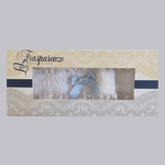 White lace garter with light blue bow by Trasparenze, boxed, available at The Foundation—classic bridal accessory for the “something blue” tradition.