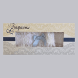 White lace garter with light blue bow by Trasparenze, boxed, available at The Foundation—classic bridal accessory for the “something blue” tradition.