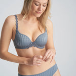 Three-quarter view of model wearing the Avero bra in Atlantic Blue, highlighting supportive plunge cups and soft sheen fabric.
