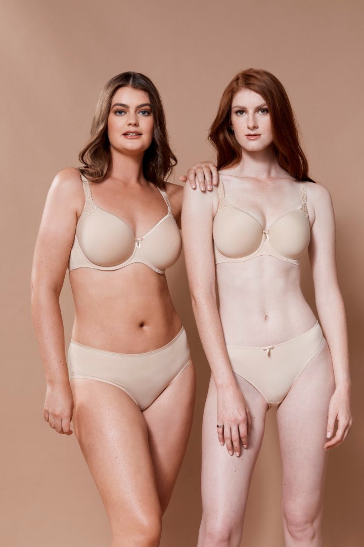Two women wearing seamless nude t-shirt bras and matching briefs, showcasing smooth, invisible fit for everyday comfort
