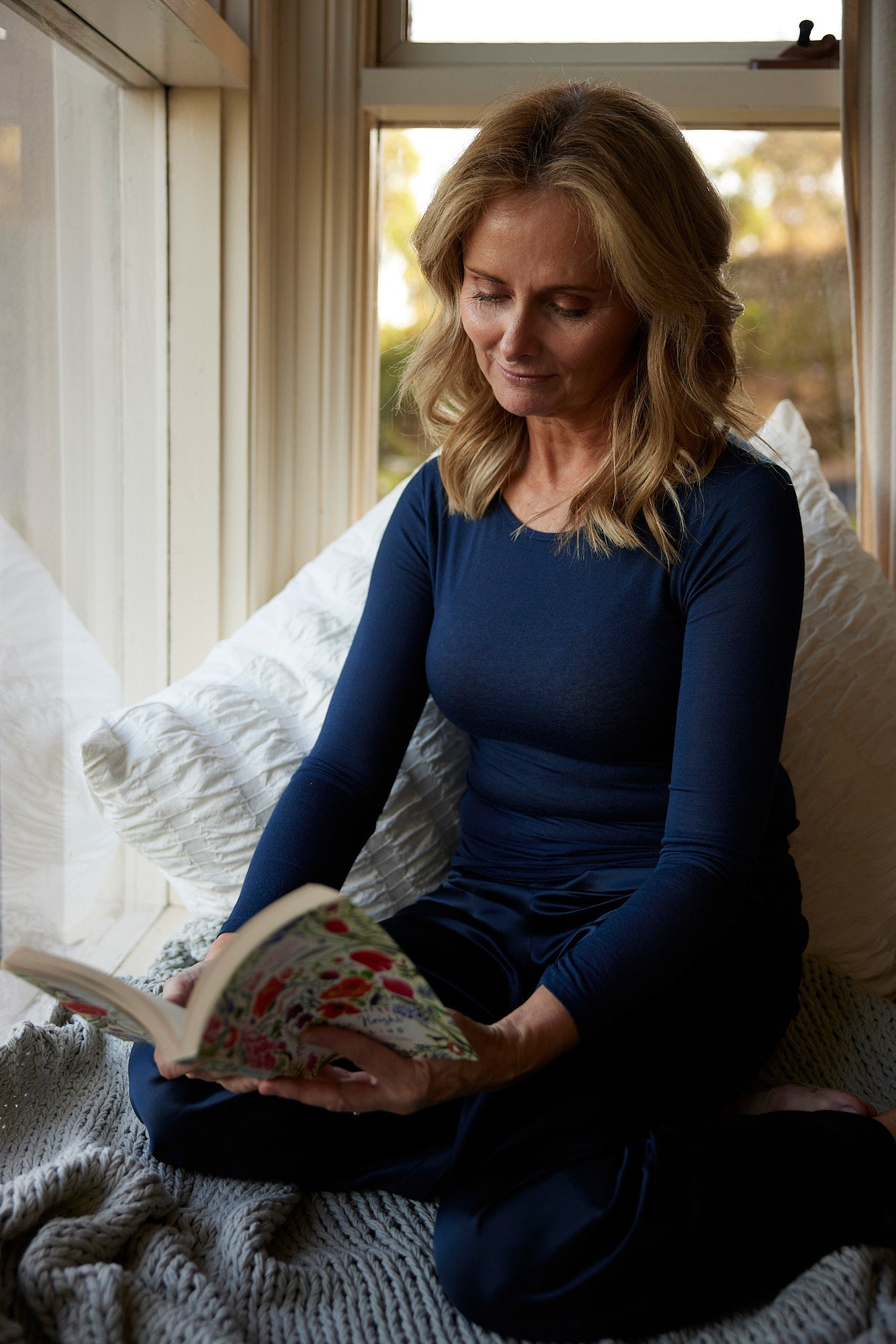 Woman wearing a long sleeve thermal top at home