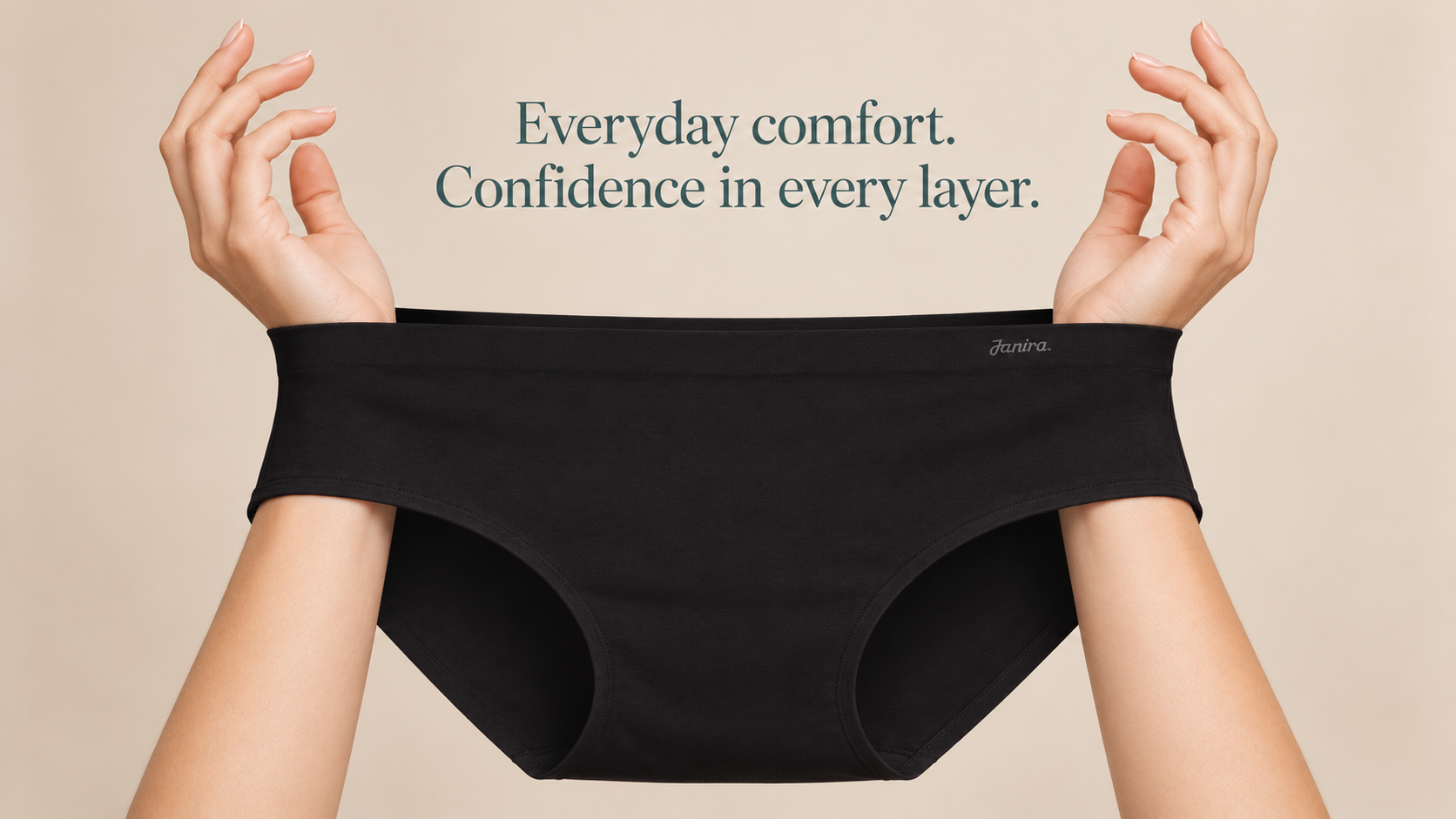 Hands stretching the waistband of black Janira full briefs against a cream background, with text reading “Everyday comfort. Confidence in every layer.