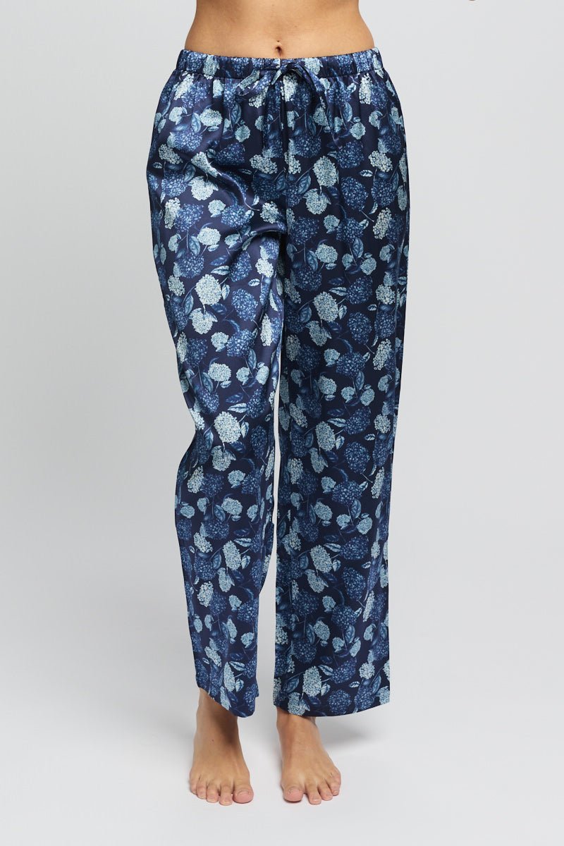 Woman wearing The Foundation’s Silk Hydrangea Print Pant in Azures Navy – wide-leg, floral silk trousers for luxurious loungewear or casual elegance.