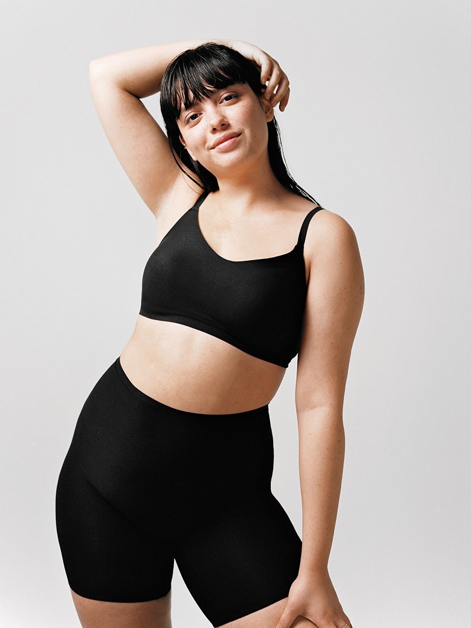 black seamless shapewear set with mid-thigh shorts providing smooth support and a natural silhouette