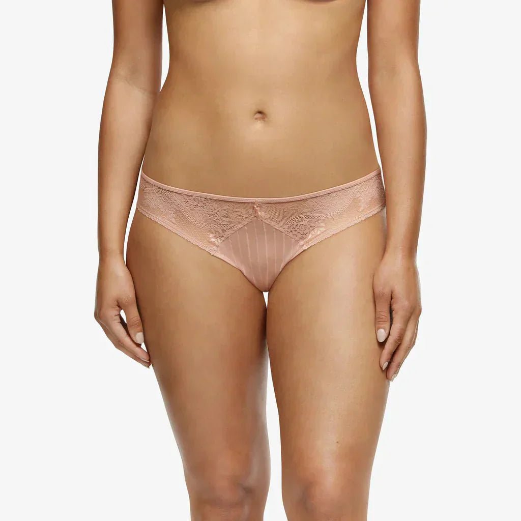 Model wearing The Foundation’s Maddie Hipster Brief in soft pink, showcasing the low-rise fit, lace detailing, and full front coverage.