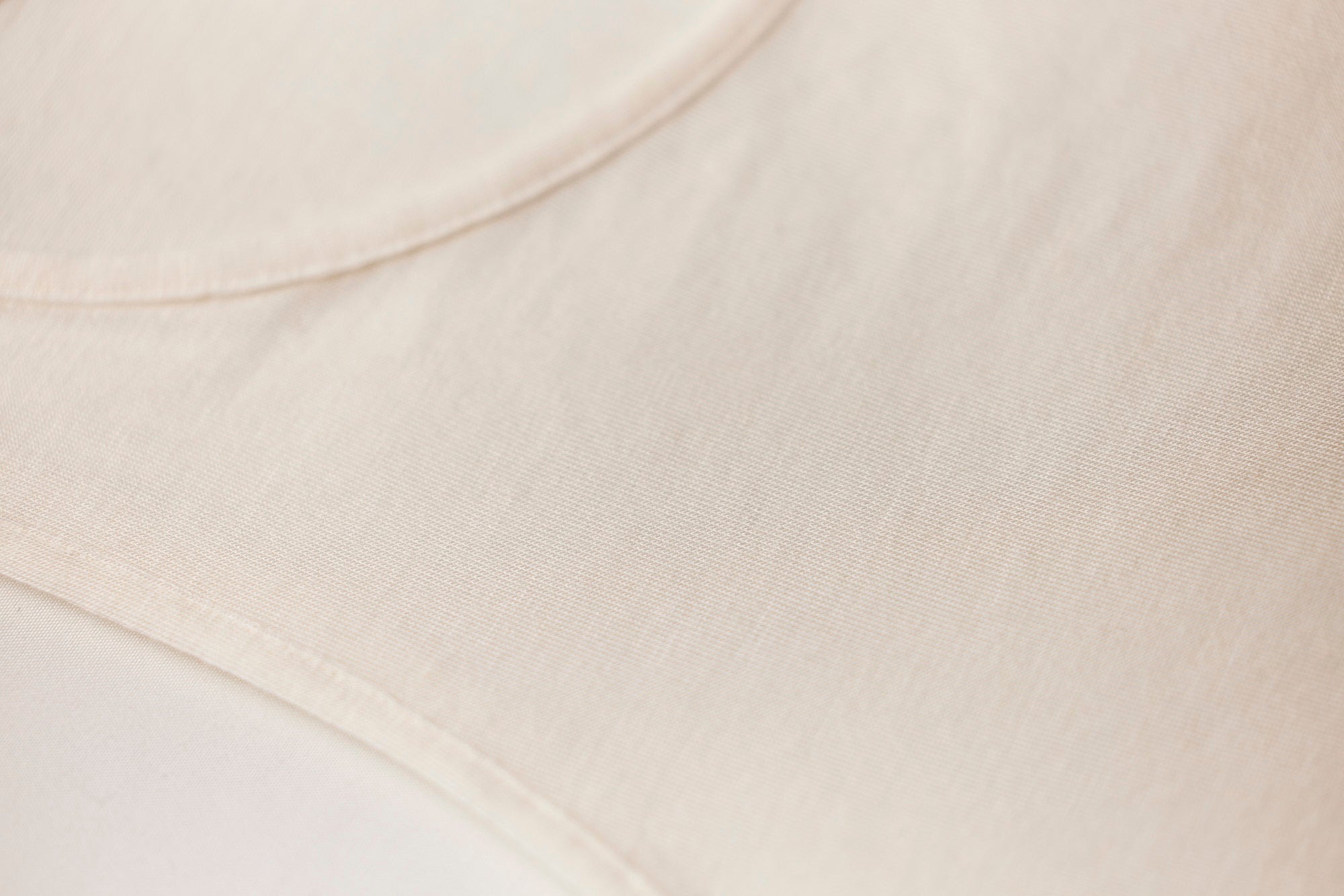 Close-up view of The Foundation’s TBL Modal Cashmere Tank Top in Ivory, showcasing the ultra-soft, cotton-like feel and lightweight thermal fabric texture.