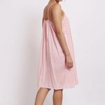 Back view of rilly Nightie in coral stripe, showing adjustable straps and gathered detail at back.