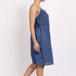 Side profile of model in navy frilly nightie, showing light drape and midi length.