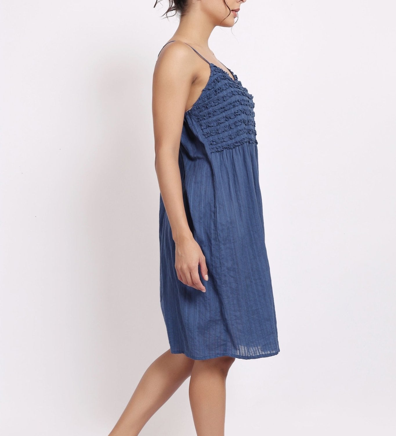 Side profile of model in navy frilly nightie, showing light drape and midi length.