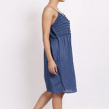 Side profile of model in navy frilly nightie, showing light drape and midi length.