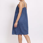 Back view of navy cotton nightie with adjustable straps and gathered fabric.