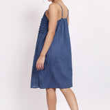 Back view of navy cotton nightie with adjustable straps and gathered fabric.