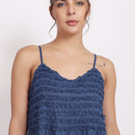 Detail of crochet frill neckline and pin tuck finish on navy self-stripe cotton.